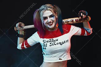 Cosplayer girl with in Harley Quinn costume. Halloween make up
