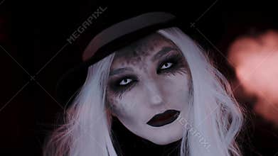 Girl in the image of a witch hat. Black background