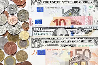 Euro and dollar bills with coins