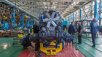 Conveyor assembly stage the body of tractor at factory timelapse