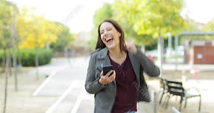 Excited woman checking phone celebrating good news