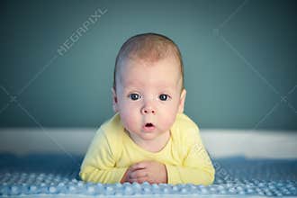 Newborn baby boy on blue carpet closeup
