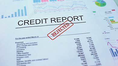 Credit report rejected, hand stamping seal on official document, statistics