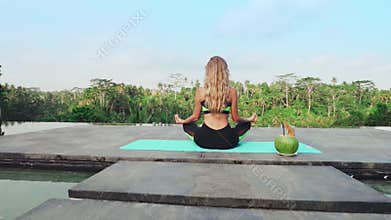 Girl meditates in a tropical country.