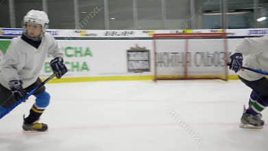 Ice hockey, school sports team on skates quickly ride on training inside a cold arena