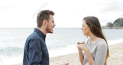 Couple breaking up on the beach