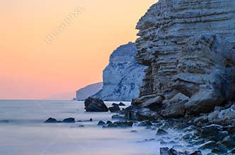 Sunset behind rock cliffs
