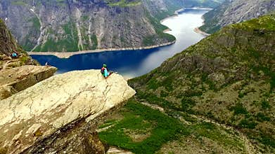 Norway. girl on the edge of the rock Trolltunga. aerial vie.