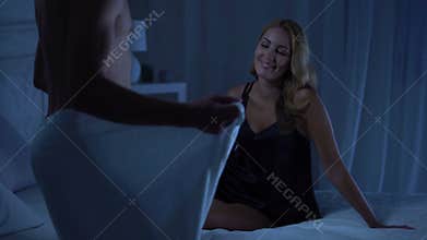 lady laughing on bed, handsome boyfriend coming in towel, foreplay