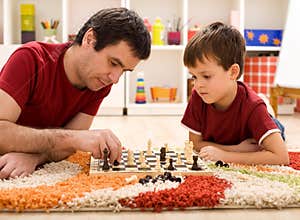 Father teaching son the rules of chess