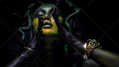 Medusa moving her hands with sharp claws with creepy look