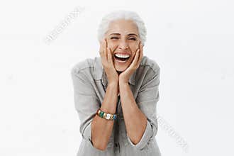 Life only starts when get older. Portrait of charming happy and carefree european senior woman with grey hair laughing
