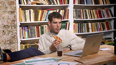 Time lapse of enjoyable caucasian male is sitting with his legs on desktop and looking at computer while drinking coke