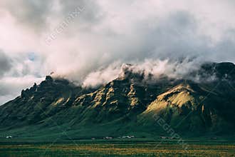Beautiful mountains with the sun clouds on the top in Iceland
