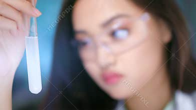 Expert chemist Asian woman studying dna biochemistry and pharmacology during scientific experiment