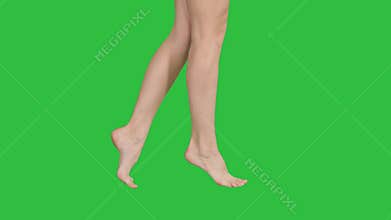 Beautiful female legs walking elegantly on tip toe on a Green Screen, Chroma Key.