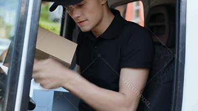 Delivery. Courier In Van Filling Documents