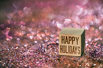 Happy holidays text with heart bokeh light