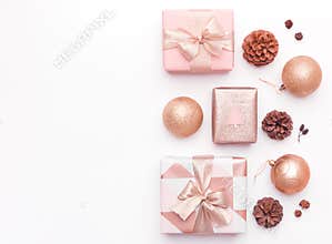Pink christmas gifts isolated on white background. Wrapped xmas boxes, christmas ornaments, baubles and pine cones.