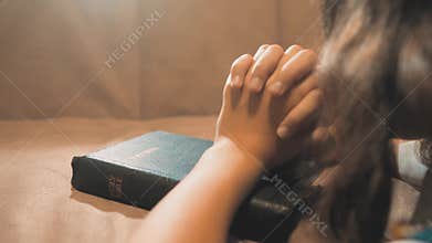 Little girl praying in the night. Little girl hand praying. little lifestyle girl holy bible prays with bible in her