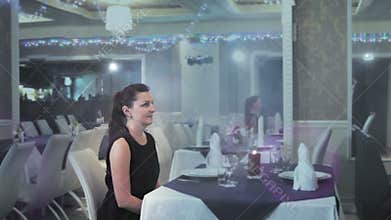 A man in a restaurant helped his wife to sit down