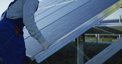Men installing solar panel outdoors