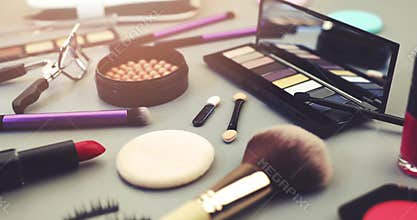 Makeup artist cosmetics set on gray table