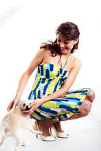 Beautiful women in short dress playing with dog
