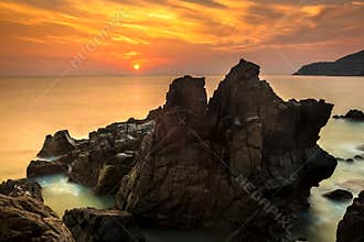 Nature Seascape with Exotic Boulders, Silky Water at Gorgeous Orange Sunrise