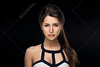 Brunette woman in stylish dress seductive looking at camera.