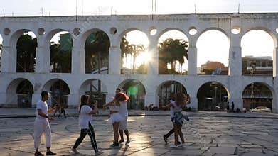 Carioca swing dancers 20-25 practice near 19th-century colonial Lapa Arches, Rio de Janeiro, Brazil -