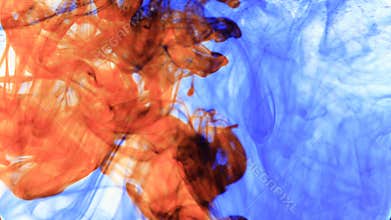 Red and blue ink that enters the water forming animated textures, footage ideal for motiongraphic and compositing