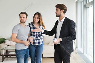 Realtor or landlord showing house apartment to young couple