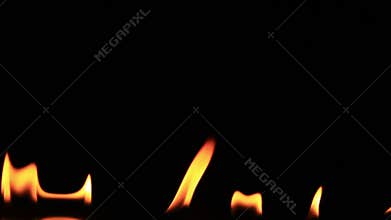 Flickering Flames Over A Reflective Black Background 