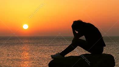 Sad girl complaining checking smart phone at sunset