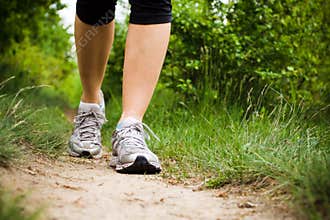 Woman walking in forest, sport shoes