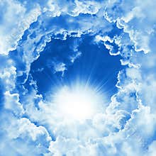 Religion concept of heavenly background. Divine shining heaven with dramatic clouds, light. Sky with beautiful cloud and sunshine