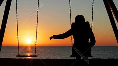 Woman alone missing her lost partner at sunset