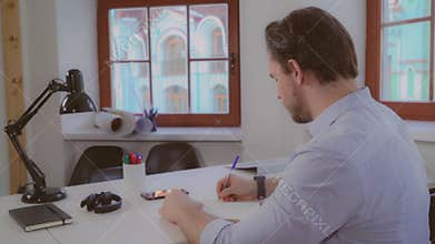 Rear back view on the male that write letter.