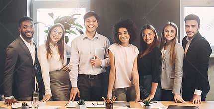 Successful business team looking at camera in office