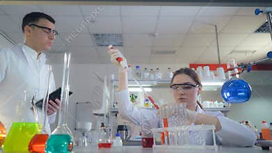 Lab technician and doctor testing something in medical laborator