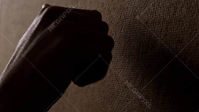 Hand knocking on wooden door