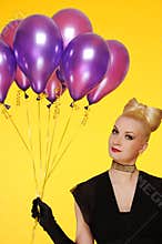 Lady with a bunch of purple balloons