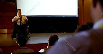 Young Caucasian disabled businessman speaking in business seminar in auditorium 4k