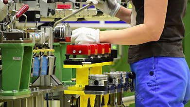 Female worker assemble a car engine