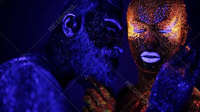 A man and a woman in the ultraviolet light caress each other. Fire and ice, two hypostases.