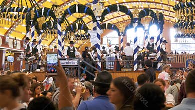 Orchestra band plays inside a large beer tent at the Oktoberfest Festival. Bavaria, Germany