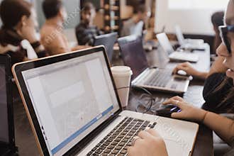 Students in classroom working with laptops
