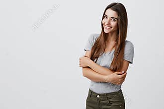 Cheerful young beautiful brunette caucasian student girl with long hair in casual stylish outfit smiling brightly