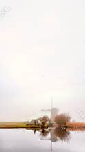 Misty and calm windmill sunrise